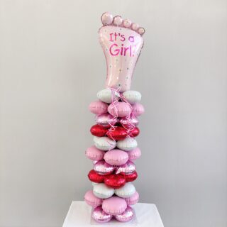 BALLOON SET WITH PINK SHOES IN A COLUMN FOR A NEWBORN GIRLCOMPOSITION OF BALLOONS WITH A PINK PRESS ON A COLUMN